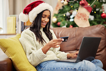 Image showing Woman, laptop and credit card, online shopping for Christmas and fintech with payment for gift and bank app. Female person on sofa, internet banking on pc and finance, e commerce for holiday present