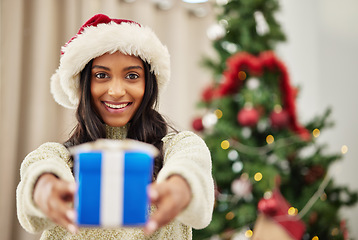 Image showing Happy woman, Christmas and gift, celebrate holiday with happiness and smile in portrait. Special event, blue box with ribbon and female person at home giving a xmas present, package and festive