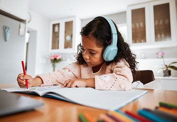 Image showing Young child, learning and homeschool with headphones for homework, writing and drawing in books. Childhood development, focus and girl kid listening to audio while studying for kindergarten education