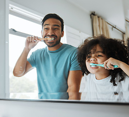 Image showing Father, son and brushing teeth together in mirror, bathroom or home for hygiene, teaching or oral care. Man, child and toothbrush with foam, cleaning and learning for health, mouth and dental results
