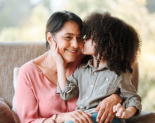 Image showing Kiss, family and grandmother with child on a sofa happy, sweet and bond in their home. Love, kissing and senior woman with girl kid in living room hug, having fun and enjoying weekend together