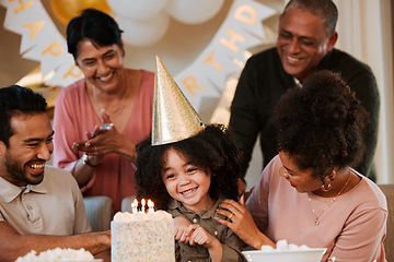 Image showing Birthday, happy and parents with cake for child in living room for party, celebration and social event. Family, surprise and excited kid with dessert, snacks and sweet treats with candles at home