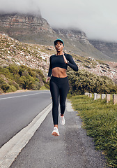 Image showing Fitness, black woman running and mountain in forest background for exercise. Workout or health wellness, motivation and body of female athlete training run for marathon in nature with sportswear