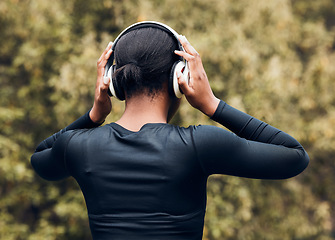 Image showing Fitness, back view of woman in woods and with headphones listening to music for workout. Exercise or committed, training or focused and female athlete listen to podcast for motivation in nature