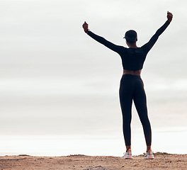 Image showing Celebration, fitness and back of woman in nature with achievement, success and workout goals. Sports, mockup space and happy female person with hands in air for exercise, training and running target