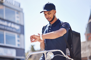 Image showing Courier, city and man check time for package, parcel and customer order delivery on bicycle. Ecommerce, logistics and male person on bike with wrist watch for travel, transport and shipping service