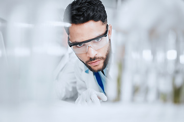 Image showing Laboratory, science and man with test tube checking results of medical study for pharmaceutical research. Healthcare, experiment and scientist in lab studying development of vaccine solution or drugs