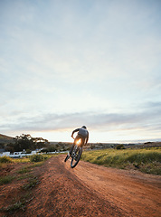 Image showing Sports, cycling and man on mountain bike in nature for training, workout and exercise in countryside. Fitness, cyclist and person with bicycle for adventure, freedom and adrenaline on dirt road