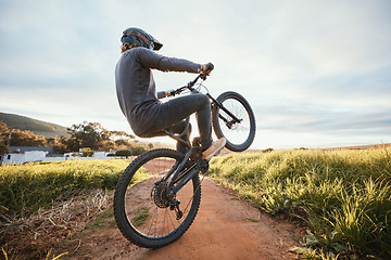 Image showing Sports, cycling and man on bicycle in countryside for training, workout and exercise in nature. Fitness, cyclist and person on mountain bike for adventure, freedom and adrenaline on outdoor dirt road