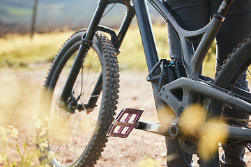 Image showing Sports, cycling and closeup of bicycle in nature for training, workout and exercise in countryside. Fitness, cyclist and person with mountain bike for adventure, freedom and ride on outdoor dirt road