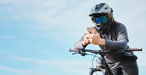 Image showing Phone, mockup and cyclist on a bicycle typing social media, online or internet for bike extreme sports communication. Outdoor, fitness and biker or person texting or search the web or website