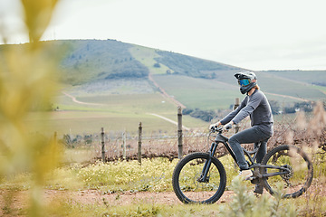 Image showing Cycling, sports and man on bicycle in countryside for training, workout and exercise in nature. Fitness, biking and male person on mountain bike for adventure, freedom and adrenaline on dirt road