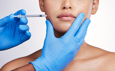 Image showing Hands, injection and face with collagen, studio and cosmetic surgery for beauty, change and lip filler by white background. Surgeon, syringe and facial transformation for patient, service or skincare