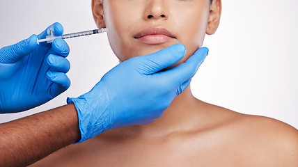 Image showing Hands, injection and face with filler, studio and cosmetic surgery for beauty, change and lips by white background. Surgeon, syringe and facial transformation for patient, service and skin aesthetic