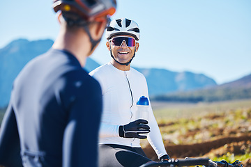 Image showing Fitness, bike and water with friends in nature for cycling, taking a break from their cardio or endurance workout. Exercise, mountain and a man cyclist team outdoor to relax during sports training