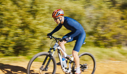 Image showing Fitness, blur or man cycling on a bicycle for training, cardio workout and race exercise in nature. Speed motion, action or sports athlete riding a bike on path off road for freedom or challenge