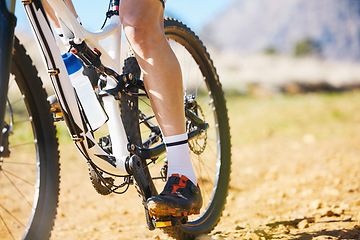 Image showing Closeup, outdoor and biker with fitness, cycling and training for a competition, road and sneakers. Zoom, male person or cyclist with workout goal, nature or travel with performance athlete or sports