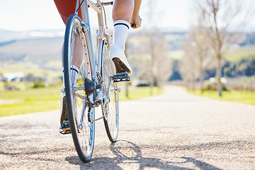 Image showing Closeup, outdoor or cyclist with fitness, bicycle or training with sneakers, health or wellness. Feet pedal, athlete or cyclist for exercise in nature or performance with wheel, travel or countryside