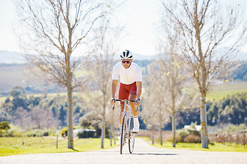 Image showing Sports, cycling and man on a bike in a park for fitness, training or morning cardio routine in nature. Bicycle, exercise and male cyclist riding on path for practice, freedom or performance challenge