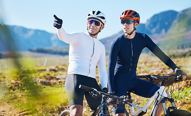 Image showing Exercise, bike and pointing with friends in nature for cycling, taking a break from a cardio or endurance workout. Fitness, mountain or countryside view with a man cyclist team training for sports
