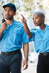 Image showing Security guard, safety officer and pointing on street for protection, patrol or watch for danger. Law enforcement, radio and serious crime prevention man and woman partner or team in uniform outdoor