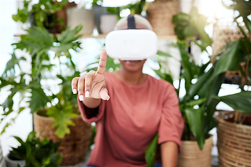 Image showing Woman, virtual reality and headset with a finger at home for metaverse, 3d world or future. Female person with plants and vr glasses for ecology, ai or hand for interaction, video game or experience