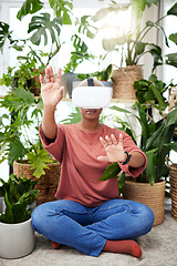 Image showing Hands, virtual reality and headset of a woman at home for metaverse, 3d world or interaction. Black person with plants and vr glasses for ecology, ai or touch for video game or online experience