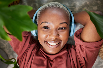 Image showing Woman, portrait and headphones for listening to music to relax with plants for peace and calm. Face of a happy black female person streaming sound, audio and podcast or radio online at home