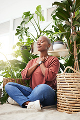 Image showing Wellness, peace and woman breathing by plants for meditation in a natural greenhouse. Breathe, gratitude and young calm African female person with a relaxing zen mindset by an indoor nursery garden.