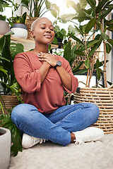 Image showing Calm, peace and young woman by plants for breathing exercise in meditation in a greenery nursery. Breathe, gratitude and African female person with a relaxing zen mindset by indoor greenhouse garden.