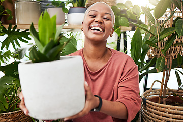 Image showing Happy, smile and woman with a plant in the greenhouse for an eco friendly or sustainable gift. Happiness, calm and African female person with green leaves in pot in the nursery for gardening at home.