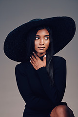 Image showing Fashion, beauty and woman in vintage hat and person thinking about event or designer clothing on show in studio background. Indian model, retro style and idea for luxury clothes or accessories