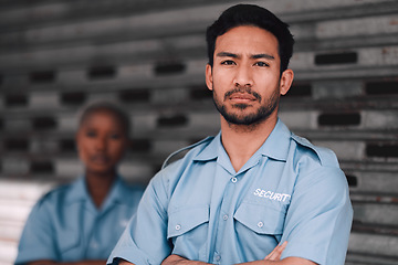 Image showing Portrait, security or safety and a serious man arms crossed with a black woman colleague on the street. Law enforcement, focus and duty with a crime prevention unit working as a team in the city