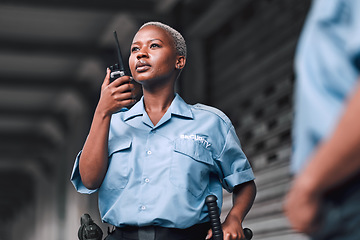 Image showing Police, communication and black woman law enforcement worker talking on walkie talkie or radio for emergency. Security, legal and officer or employee doing criminal investigation for justice