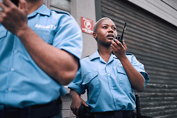 Image showing Security, walkie talkie and a black woman police officer in the city during her patrol for safety or law enforcement. Radio, communication and service with a female guard on a street in an urban town