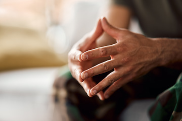 Image showing Hands clasped, soldier sitting and military person with anxiety, depression or problem on sofa. Army man, couch and ptsd, stress and crisis after war, trauma and waiting in living room alone in home