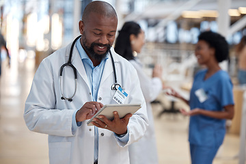 Image showing Doctor, black man and tablet for medical planning, data research or healthcare app in busy hospital. Happy male surgeon, digital technology and consulting information on telehealth schedule in clinic