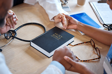 Image showing Hands, bible and a healthcare team praying for a miracle curing a meeting in a hospital office together. Medical, trust or teamwork with doctors and nurses asking God or Jesus for help in a clinic