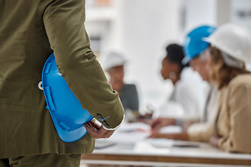 Image showing Man, architect and hands in meeting for construction, teamwork or project plan with safety helmet at office. Hand of contractor with hard hat or team for industrial architecture, strategy or planning