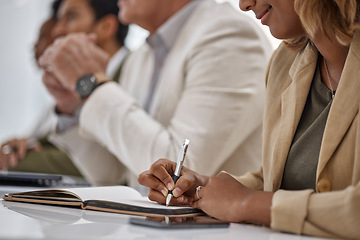 Image showing Woman, hands and writing in book for meeting notes, information or minutes on office desk in boardroom. Hand of female person or employee in team planning, strategy or brainstorming in notebook