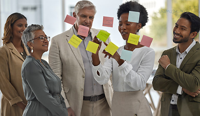 Image showing Meeting, presentation and glass with a black woman leading a presentation in a boardroom for company strategy. Teamwork, planning and sticky notes in an office with a female employee talking to staff