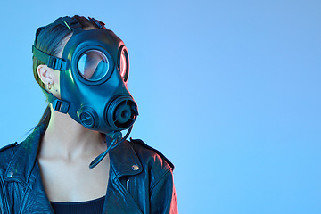 Image showing Mockup, protection and woman with a gas mask, breathing equipment and air pollution against a blue studio background. Female person, model and face cover with climate change, filter and radioactive