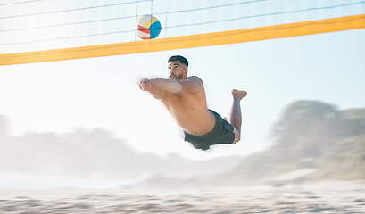 Image showing Volleyball, diving and man jump at beach in air for fun competition, contest and motion blur. Male person, outdoor fitness and hit ball at sand by sea for summer games, action and energy performance