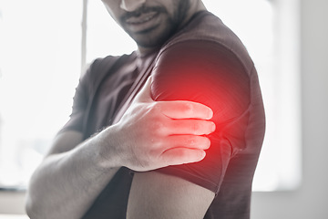 Image showing Hand, arm pain and injury with a man shoulder in red highlight during a fitness workout. Healthcare, medical and anatomy with a male athlete holding a joint after an accident or emergency in the gym