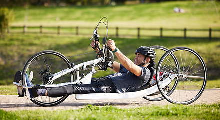 Image showing Cycling, fitness and health with man and handcycle in nature for training, sports and challenge. Exercise, workout and wellness with person with a disability in park for cardio and bicycle marathon