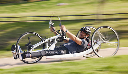 Image showing Cycling, fitness and fast with man and handcycle in nature for training, sports and challenge. Exercise, workout and cardio with person with a disability in park for motion blur, marathon and health