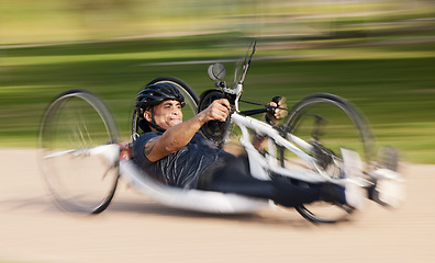 Image showing Cycling, fitness and man with disability, speed and training for competition and exercise on bike. Motion blur, workout and person on fast recumbent bicycle on outdoor race track for challenge