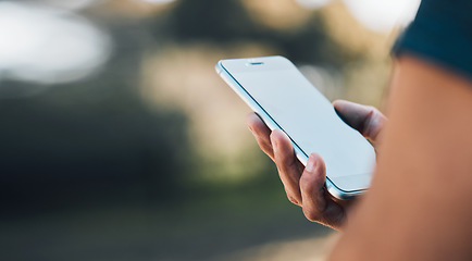 Image showing Closeup hands, phone and communication for social media, networking or chat on mockup screen in nature outdoors. Person, mobile or smartphone app for texting, online browsing or mock up space banner