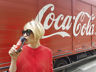 Image showing Kyiv, Ukraine - July 6, 2017 Beautiful fashionable woman with model release drinking Coca-Cola soda