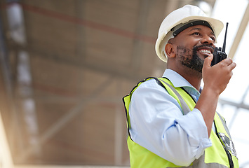 Image showing Radio, black man and engineer planning, communication and construction. African architect, walkie talkie and happy contractor with industrial project, building maintenance and engineering discussion.